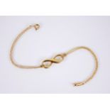 An 18ct gold infinity bracelet by Tiffany & Co, the pierced infinity link measuring 21mm x 8mm,