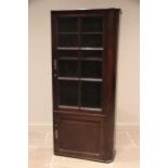 A 19th century mahogany freestanding bookcase, rounded to the right hand side, the single glazed