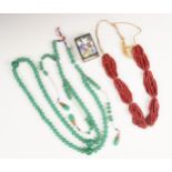 A Chinese jade coloured glass bead necklace, designed as a single row a off-round jade coloured