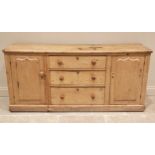 A Victorian pine kitchen dresser base, the three central graduated drawers applied with hardwood