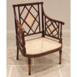 A Regency mahogany open work armchair, the lattice work back panel and sides enclosing the wide