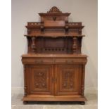 A late 19th/early 20th century French carved oak and rouge marble buffet sideboard, the