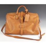 An Alfred Dunhill of Mayfair tan leather holdall, with lacquered brass hardware stamped 'AD 1893',