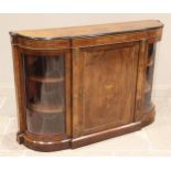 A Victorian figured walnut bow front credenza, the book veneered top with a moulded ebonised edge