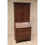 A late 18th/early 19th century oak bureau bookcase, the moulded cornice above a pair of panelled