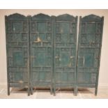 A painted hardwood Indian four panel room screen, each panel constructed from an arrangement of