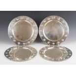 A set of four Mexican silver chargers, each of circular form with embossed roundels to borders,