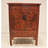 A red lacquer Chinese wedding cabinet, 20th century, probably elm, the twin doors adorned with