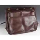 A Swaine, Adeney & Brigg brown leather garment bag, with lacquered brass hardware unbuckling to