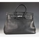 A Hermes Birkin 40 handbag, circa 2009, the black clemence leather bag with double top handle and