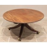 A Regency mahogany centre table, the circular top with a beaded rim, raised upon a reduced