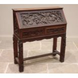 A Chinese relief carved hardwood bureau, 20th century, the fall front carved with warriors on