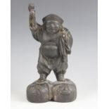 A Japanese bronze Daikoku figure, Meiji Period (1868-1912), modelled standing with bag and mallet,