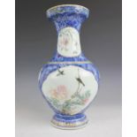 A Chinese porcelain famille rose vase, Yongzheng (1722-1735), of baluster form and decorated with