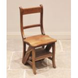A metamorphic hardwood library steps/chair, the rail back chair with hinged seat converting into a
