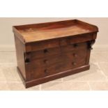 A mid 19th century mahogany tray top chest, the rectangular top with a three quarter gallery over