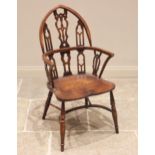 An oak and ash Gothic revival Windsor chair, the pointed arched back with pierced and interlaced