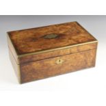 A Victorian figured walnut stationery box, the hinged cover centred with a shaped brass cartouche,