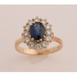 Gold entourage ring with diamond and sapphire