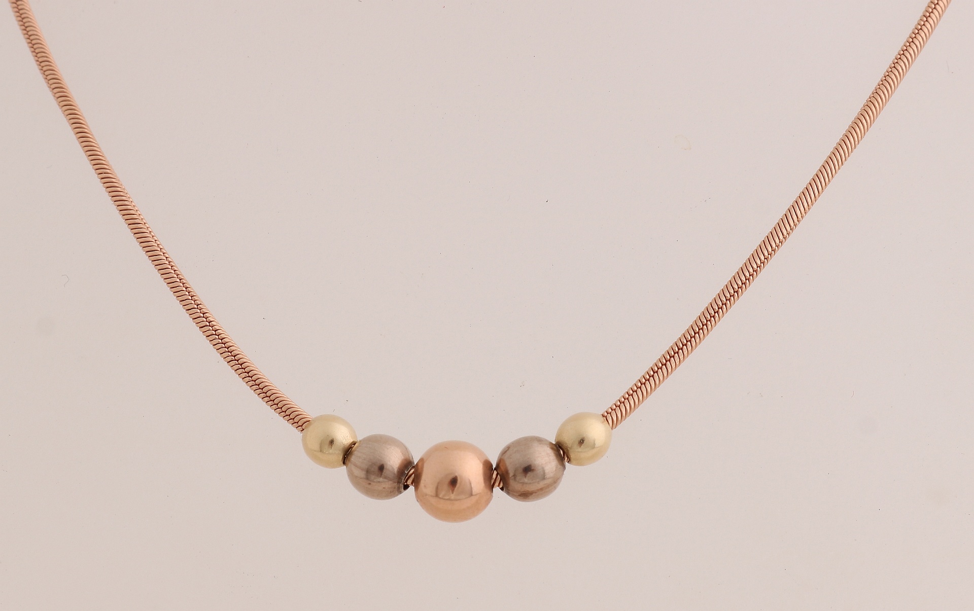 Golden necklace with spheres