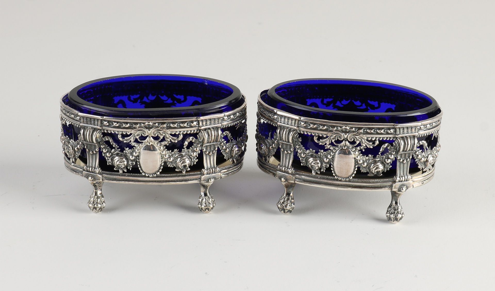 Two silver salt shakers