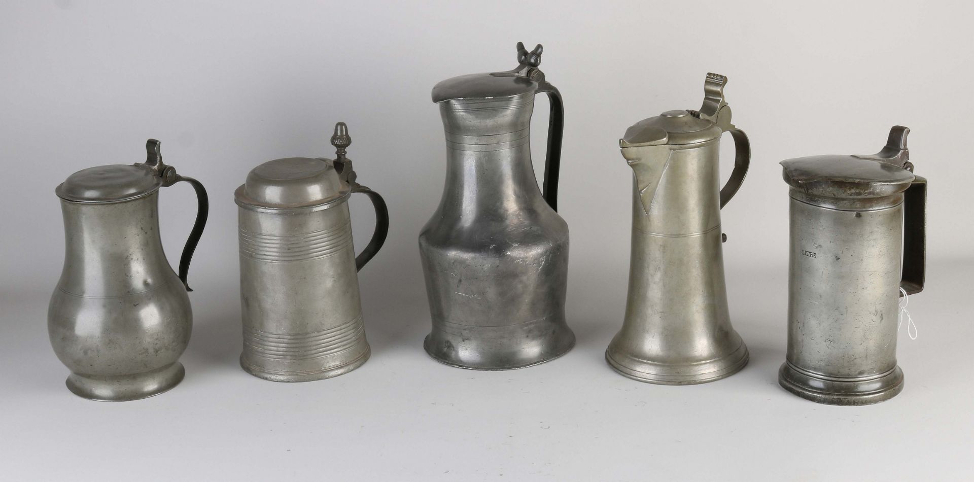 Five antique pewter valve jugs