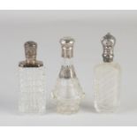 Three perfume bottles with silver