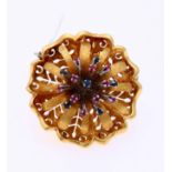 Golden brooch flower with sapphire and ruby