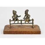 Group of bronze figures, Boy and girl on fence