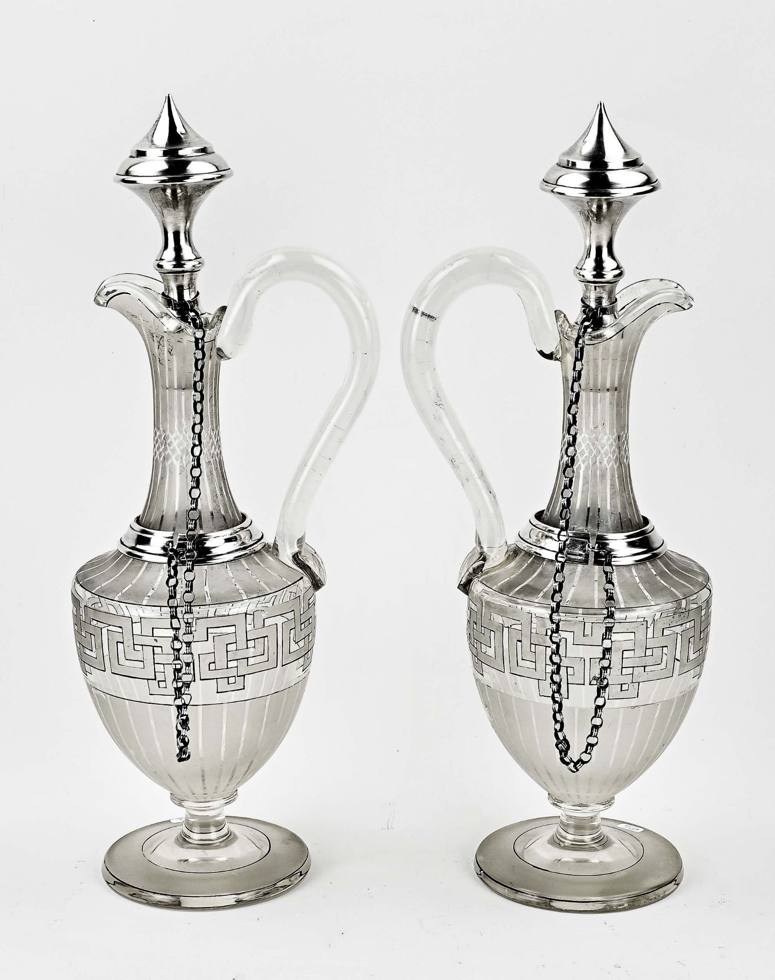 Two decanters with silverware