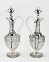 Two decanters with silverware
