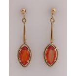 Gold earrings orange stone