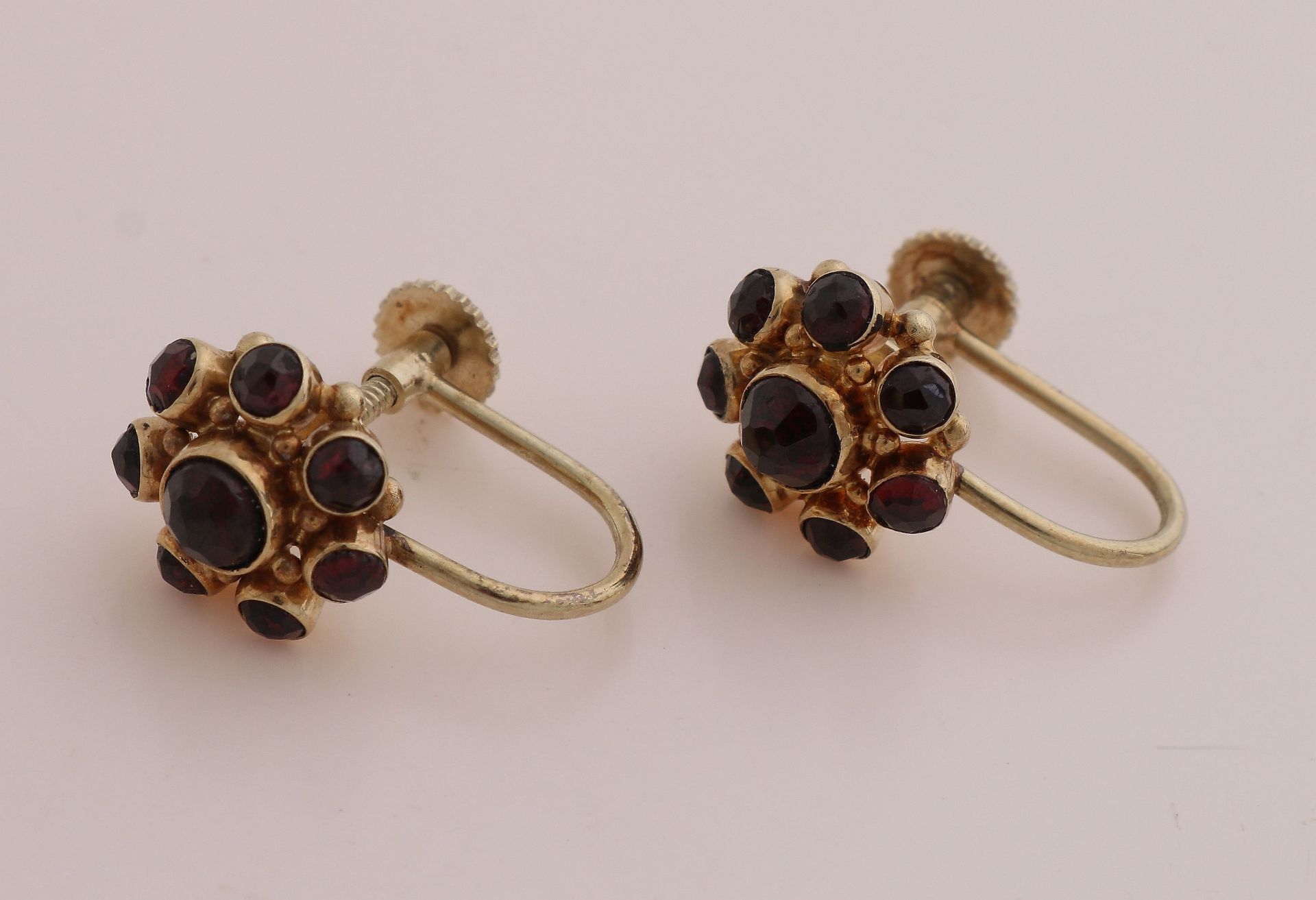 Gold ear screws with garnet