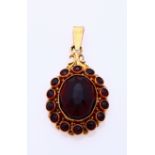 Gold pendant with garnet