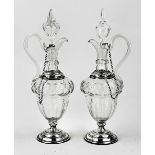 Two decanters with silverware