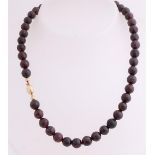 Necklace with garnet with gold lock