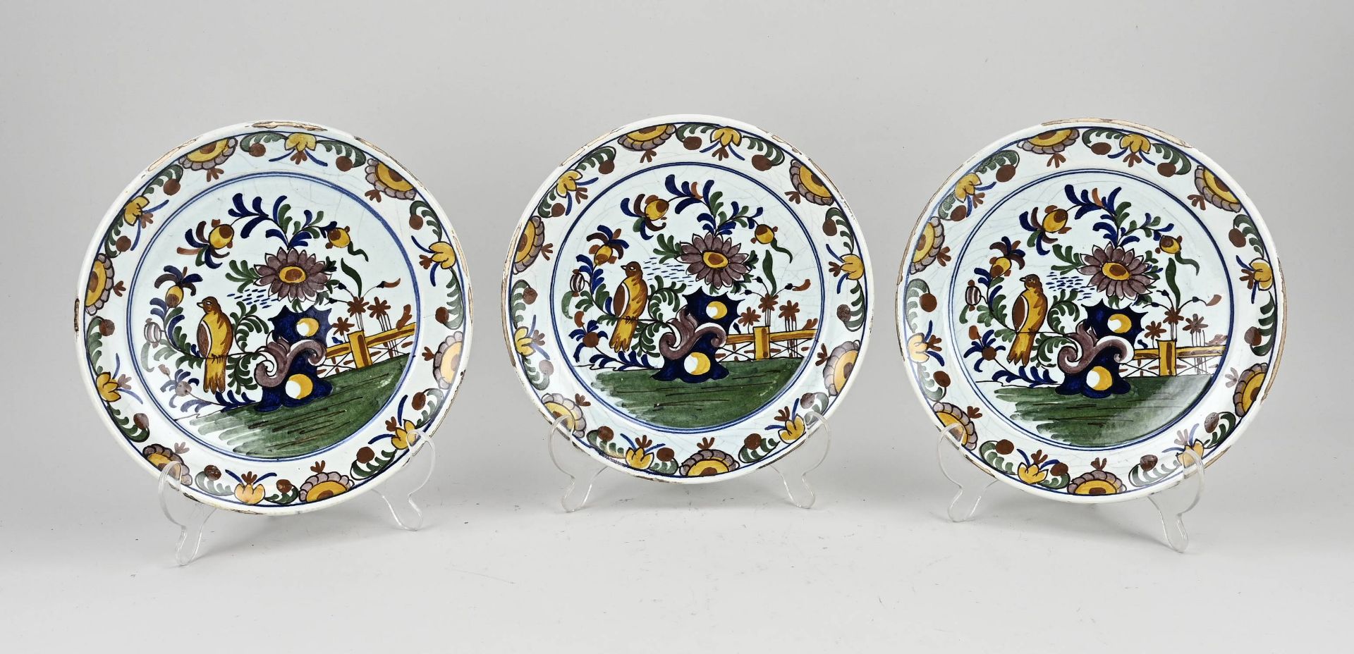 Three antique Delft plates Ø 23 cm.