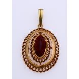 Gold pendant with garnet