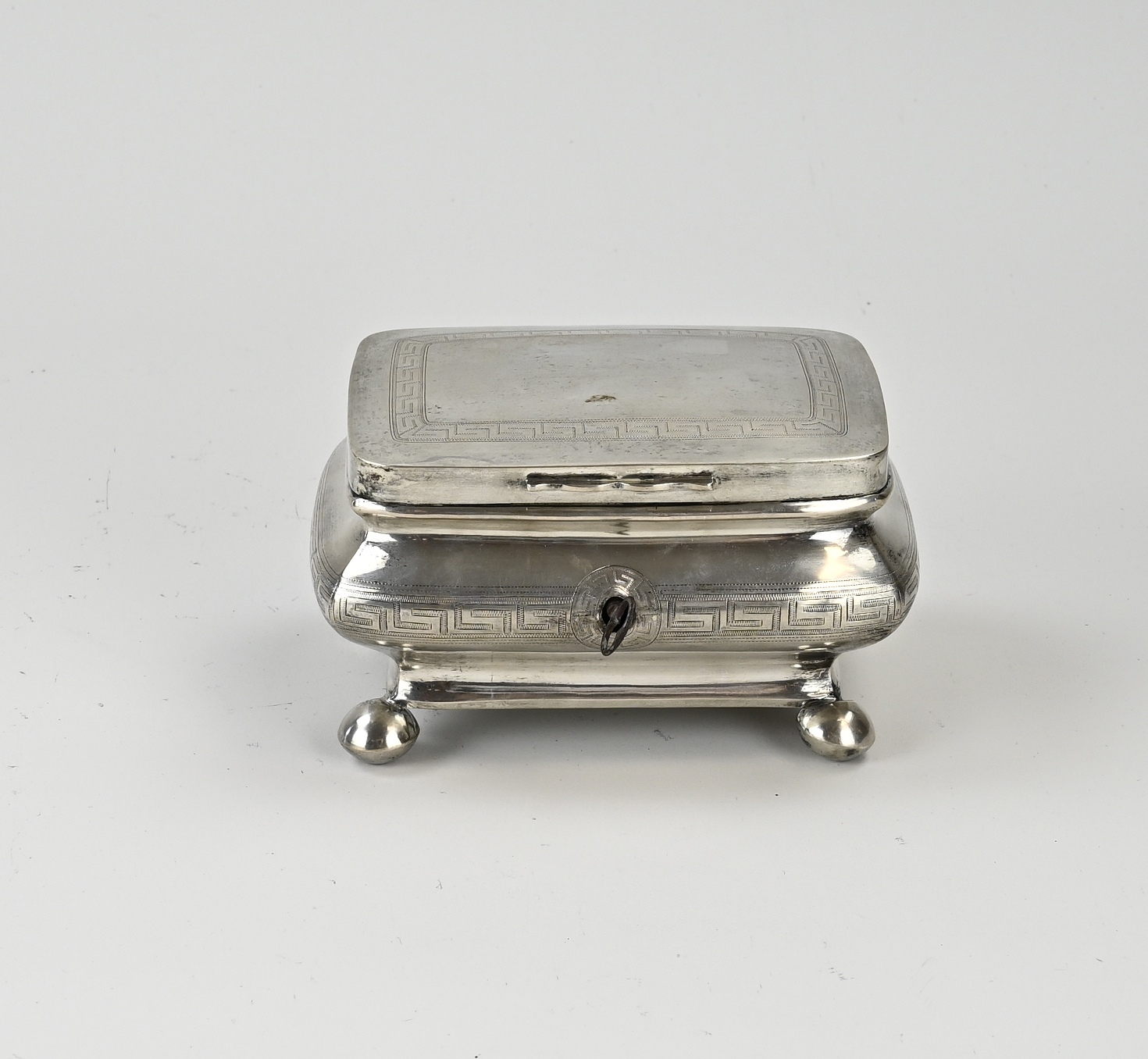 Silver tea box with key