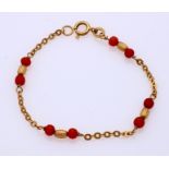 Gold bracelet with red coral