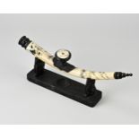 Chinese bone opium pipe on stand