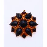 Gold brooch with garnet