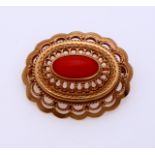 Gold brooch with red coral