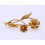 Gold brooch in flower shape