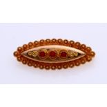 Gold brooch with red coral