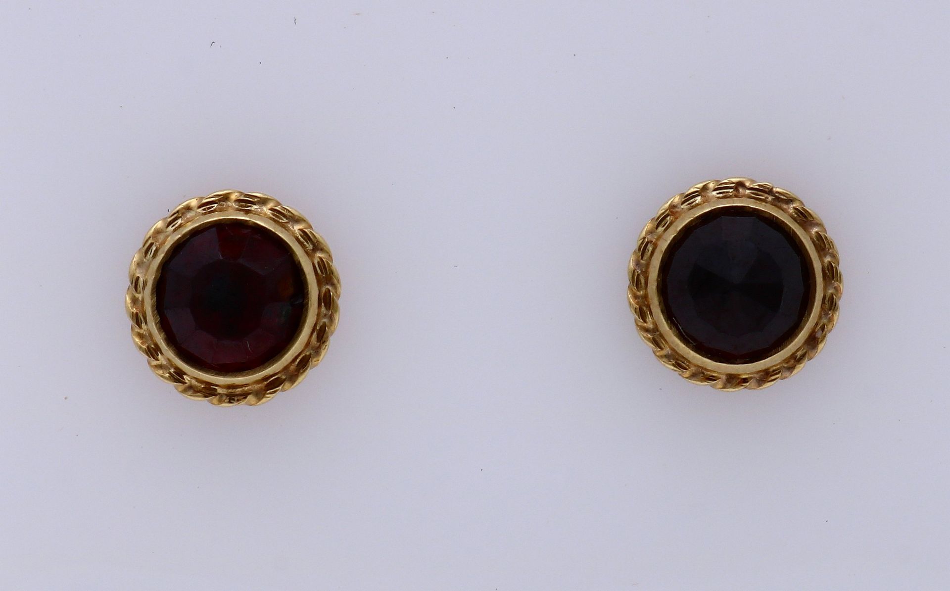 Gold ear studs with garnet