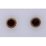 Gold ear studs with garnet