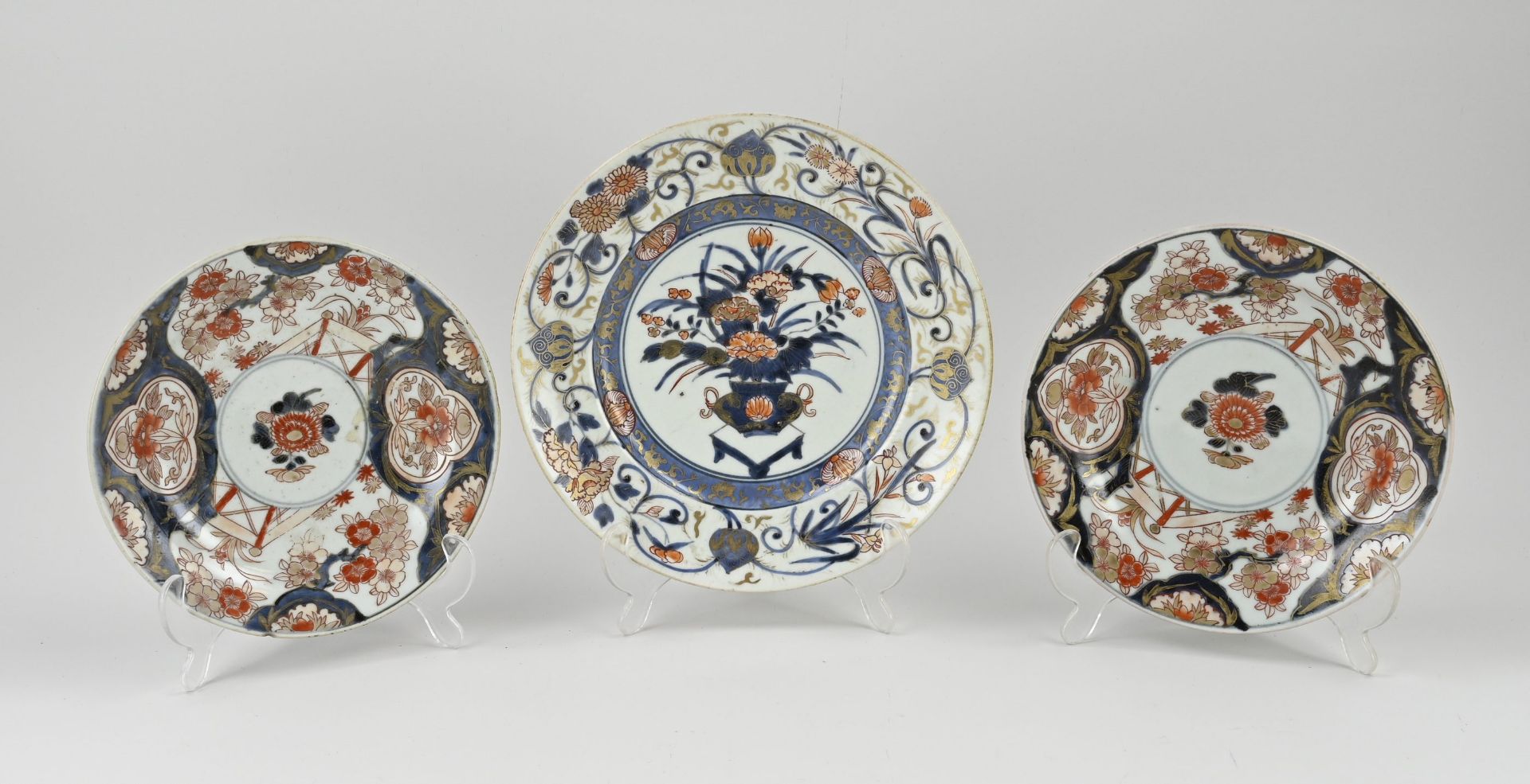 Three 18th century Japanese Imari plates Ø 20 - Ø 24 cm.