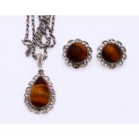 Silver pendant and earclips with tiger eye