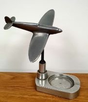 A metal desk ornament with model of a RAF Spitfire, 6.5 inches in height. Spitfire can be rotated.